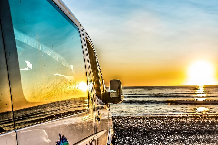 Experience the serene beauty of Kaikoura as you travel along the stunning coastline where mountain ranges frame the tranquil Pacific Ocean at sunset promising unforgettable moments and wildlife encounters.